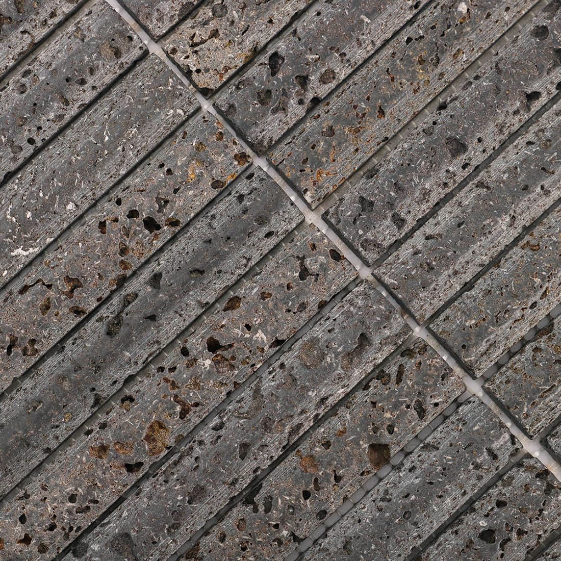 Macro view of gray stone mosaic showing natural pits and texture