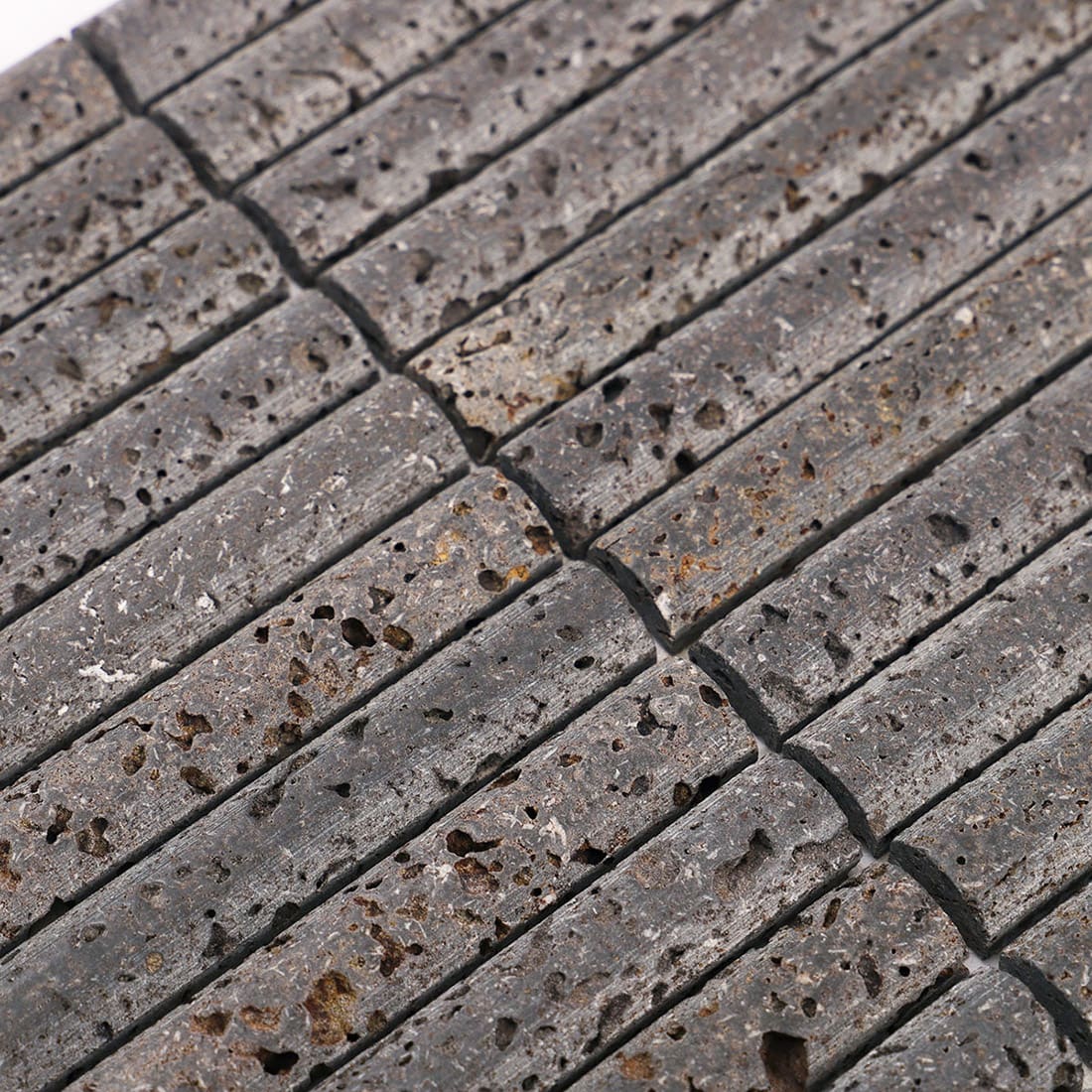 Close-up of gray linear stone mosaic pattern with grout joints
