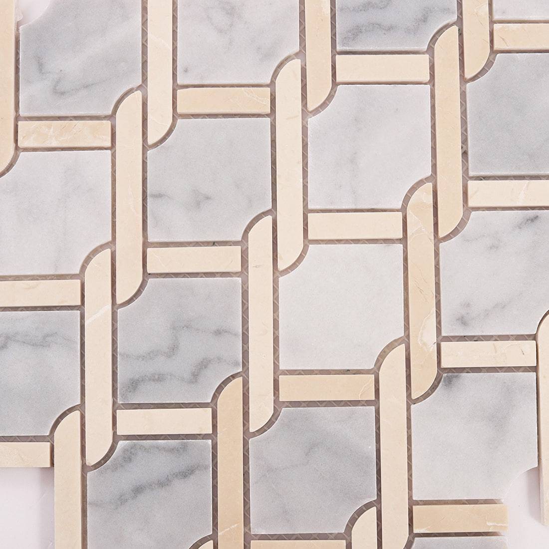 Detailed view of gray marble squares and beige links with visible grout spacing