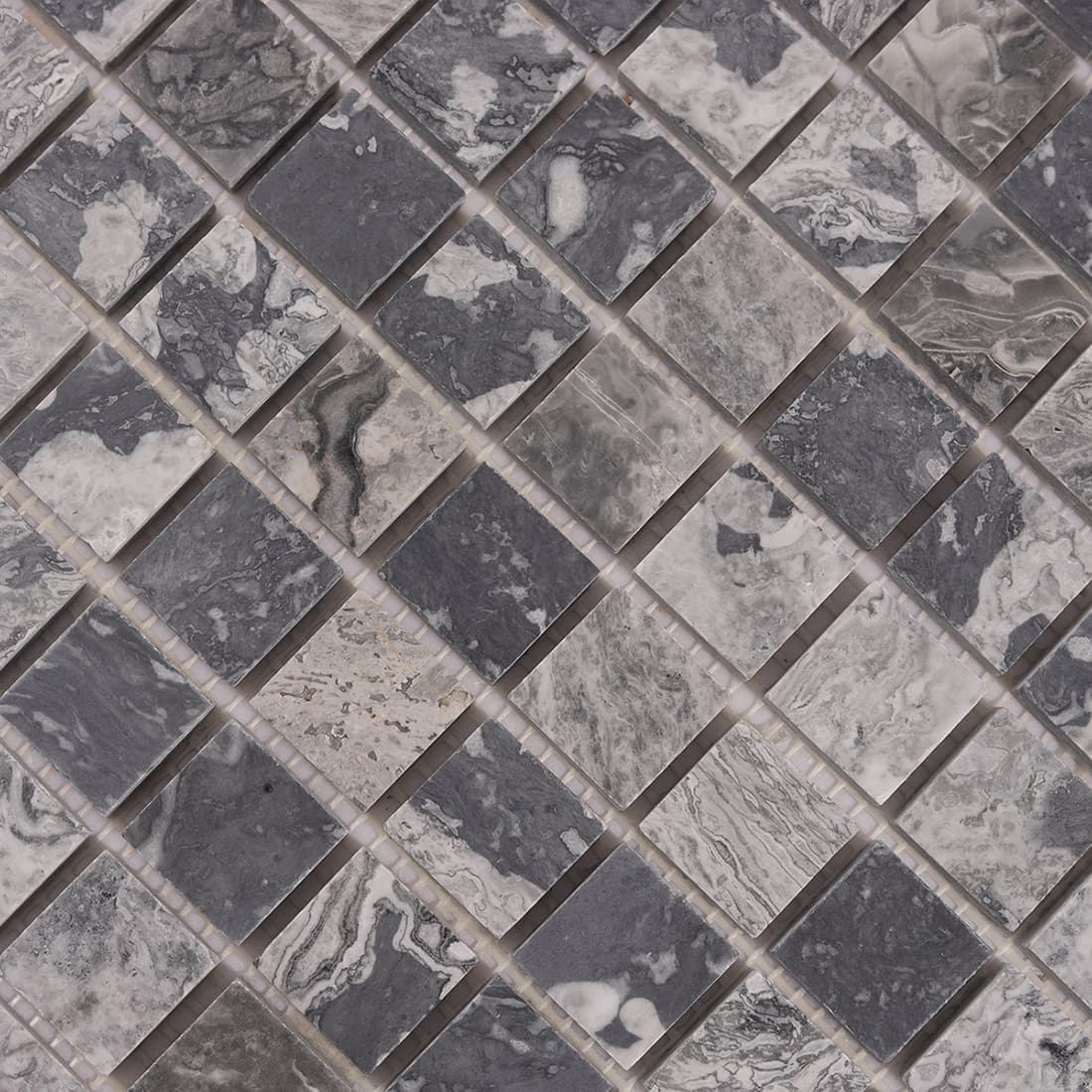 Close up of gray marble square mosaic tiles showing natural texture
