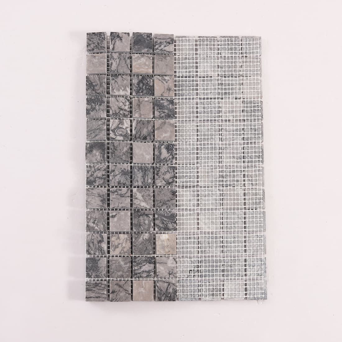 Back view of gray marble square mosaic tiles on fiberglass mesh