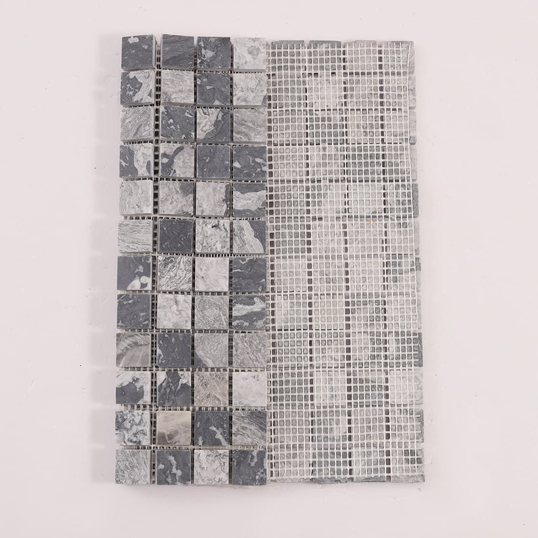 Back view of gray marble square mosaic tiles with fiberglass mesh backing