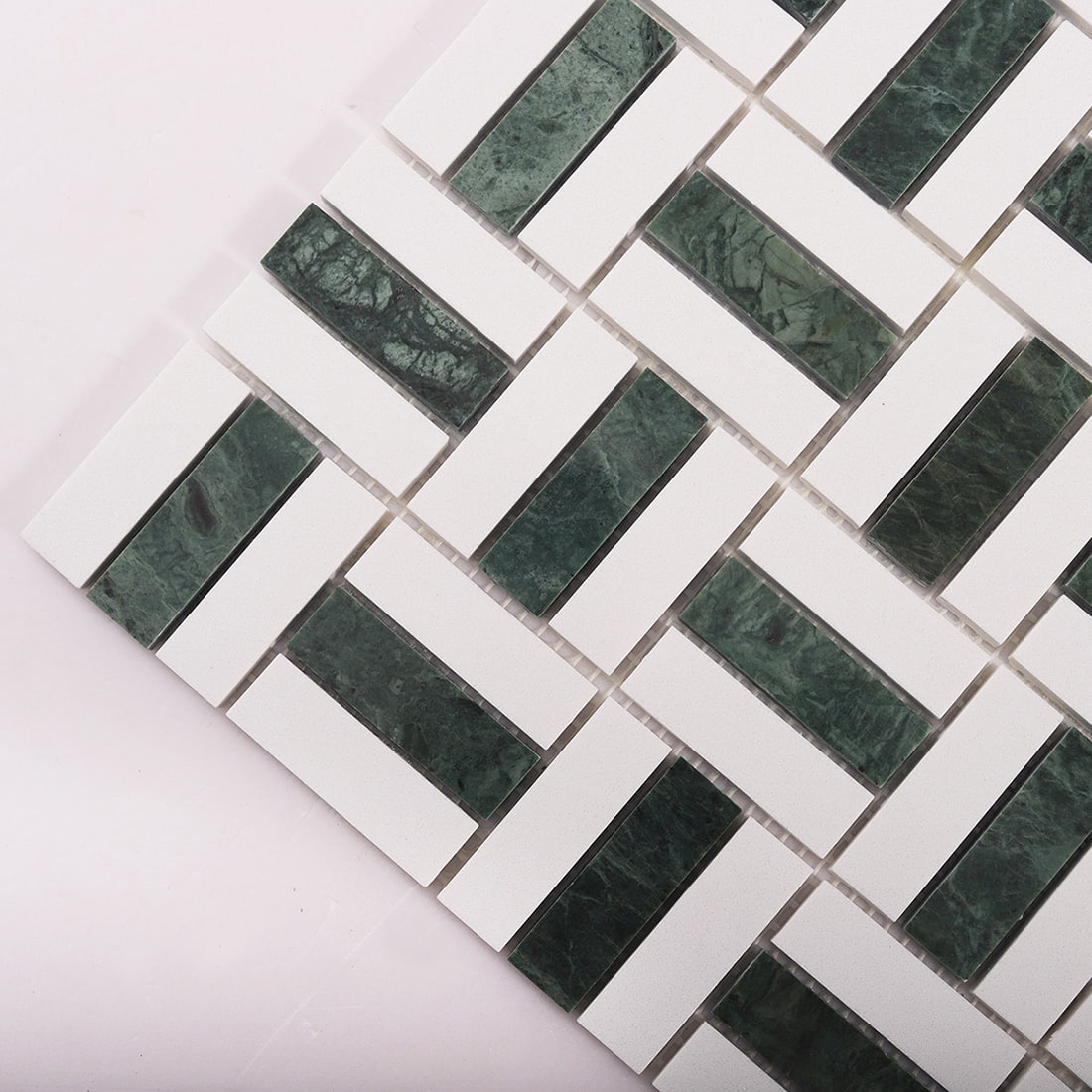 Diagonal close-up of green and white basket weave mosaic tiles