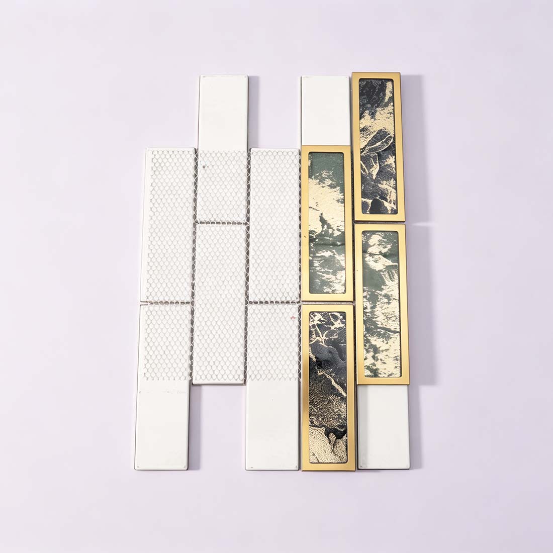 Green and black gold-framed mosaic tiles displayed beside white tile samples