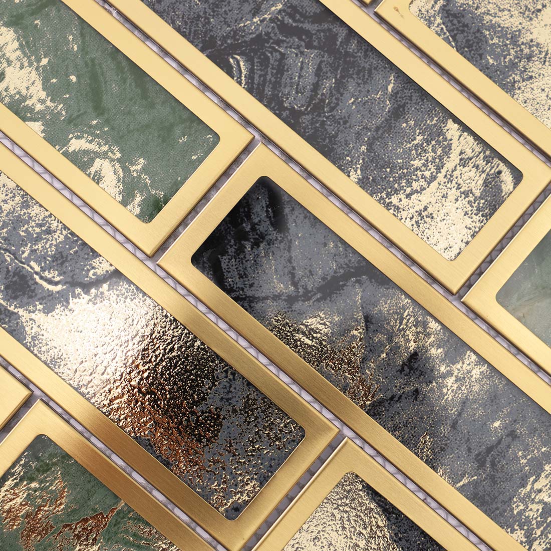 Detailed view of textured green and black mosaic tiles in gold metal frames
