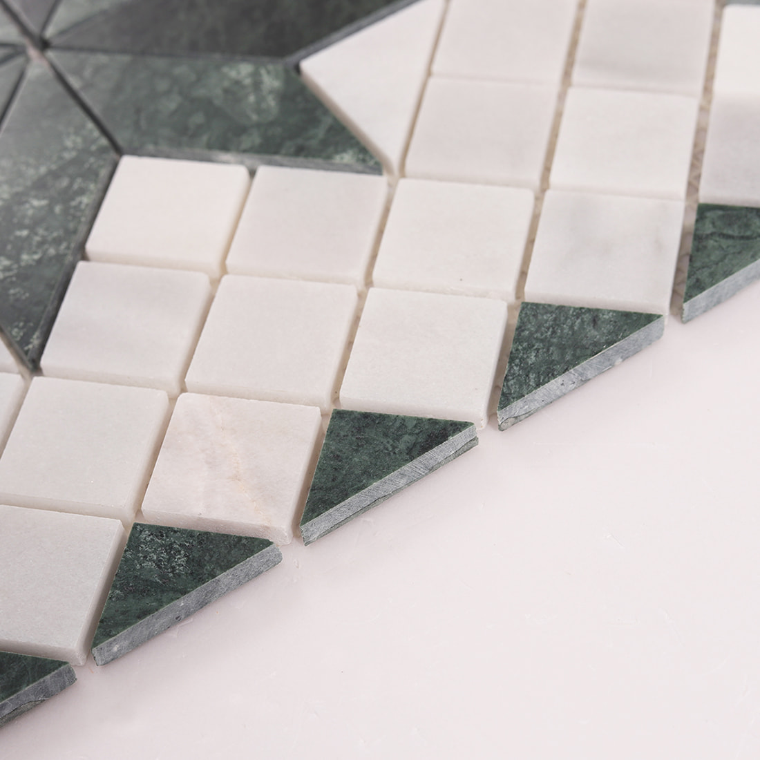 Side view showing thickness of green marble and Carrara white mosaic tile
