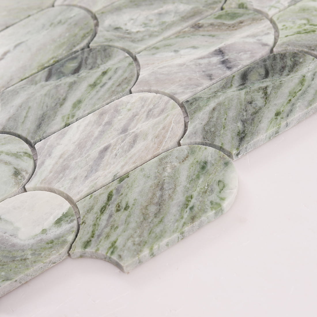 Angled close up of green marble arch picket mosaic tiles highlighting thickness