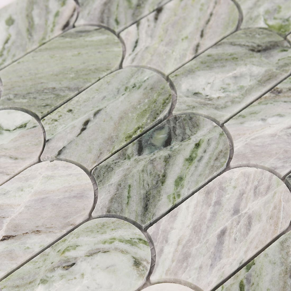 Detailed view of green marble veining on arch picket mosaic tiles