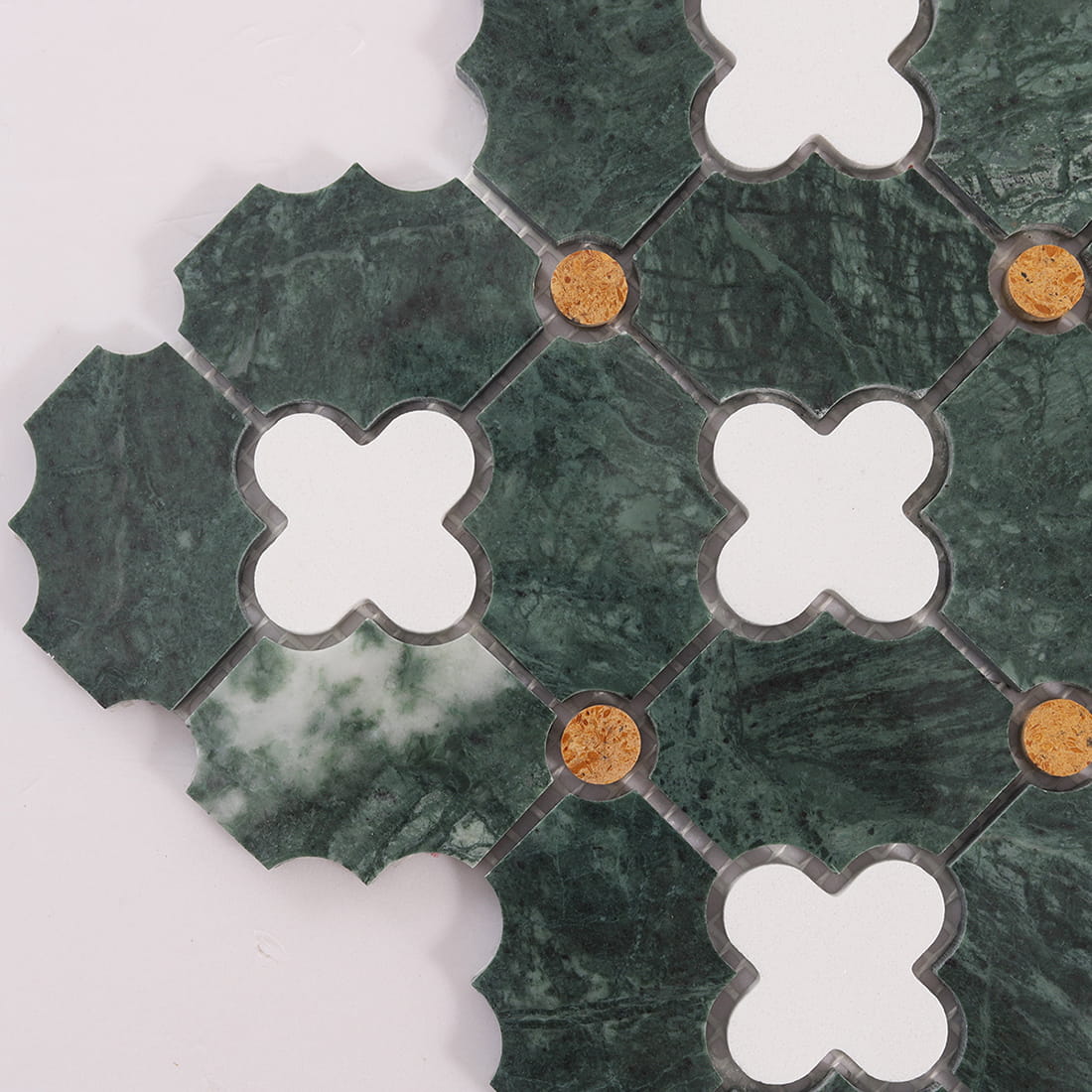 Close up of tile sheet corner showing green marble, white clovers, and gold dot accents