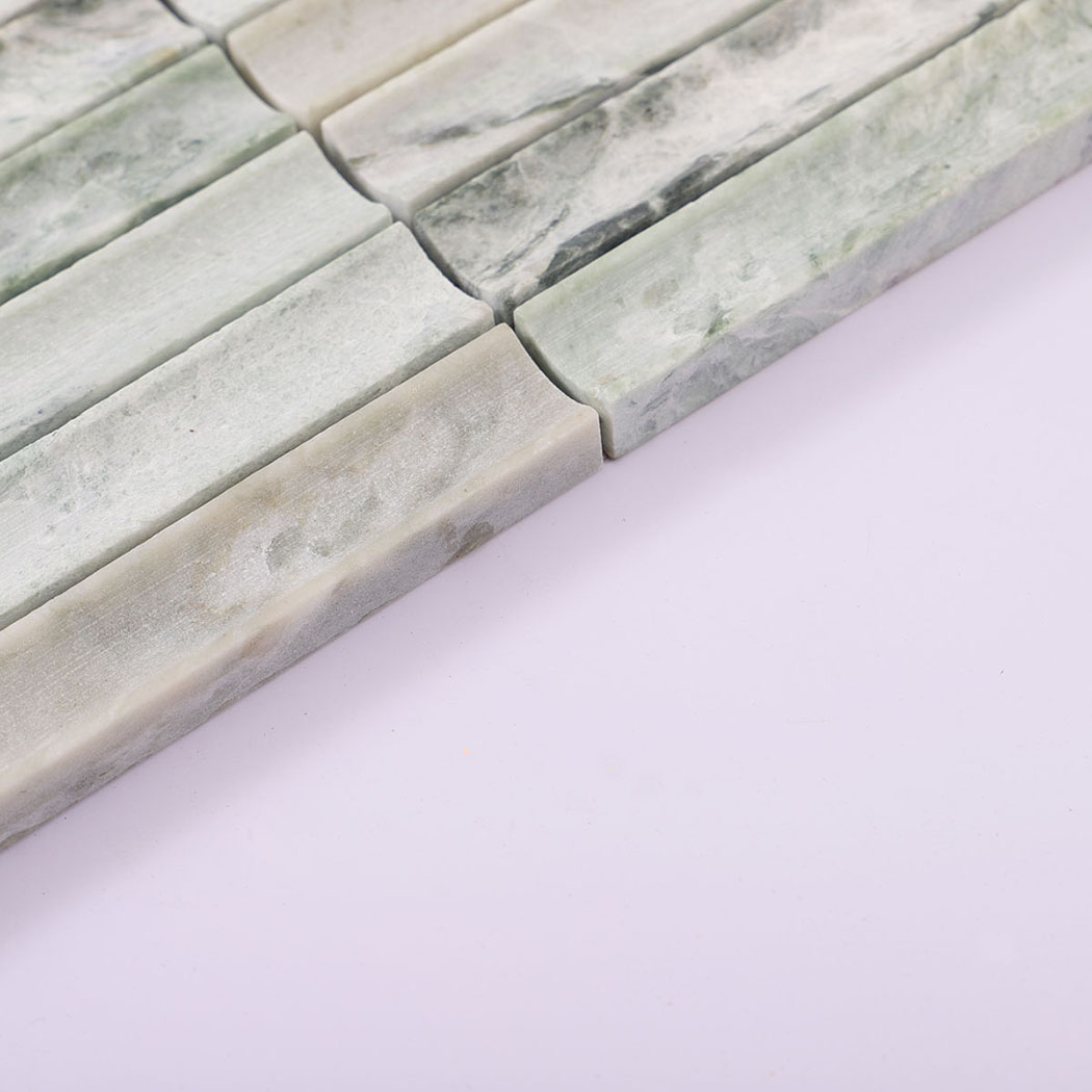 Edge view of pale green marble concave strip mosaic showing tile thickness