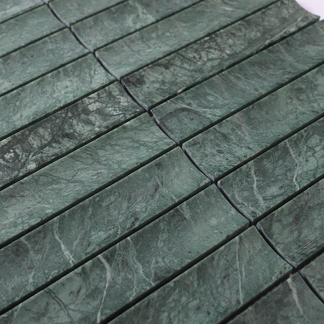 Dark green marble strip mosaic showing natural veining and spaced joints