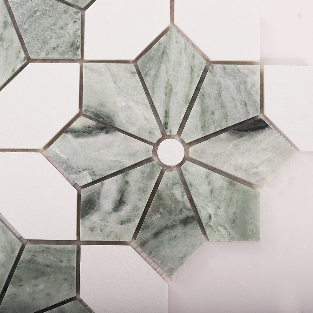 Close up top view of green marble flower mosaic with a white center dot