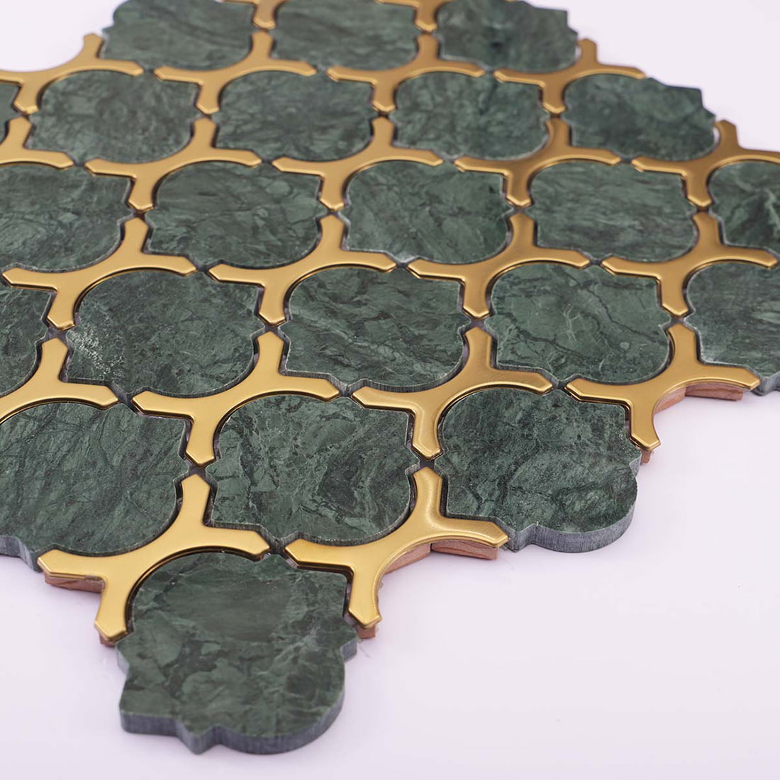 Angled view of green marble and gold stainless steel mosaic tile