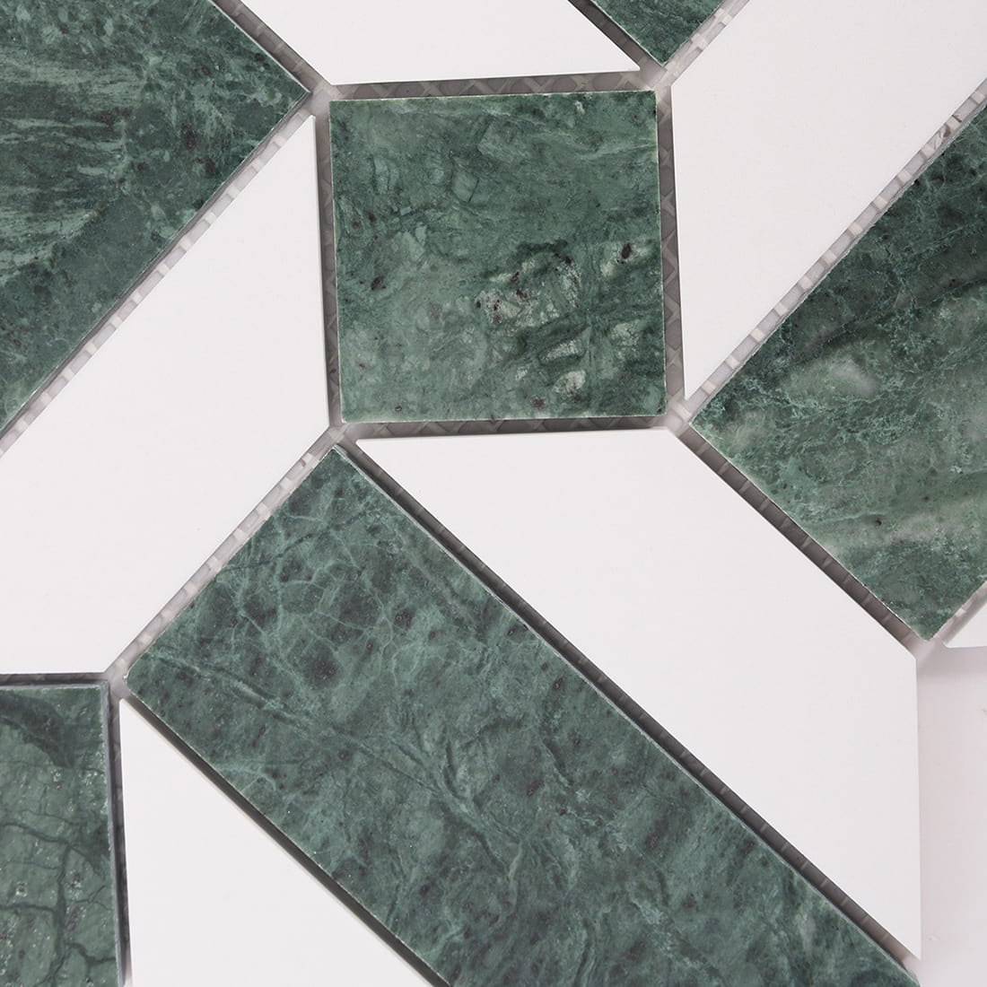 Detail of green marble square insert with white marble shapes and grout spacing