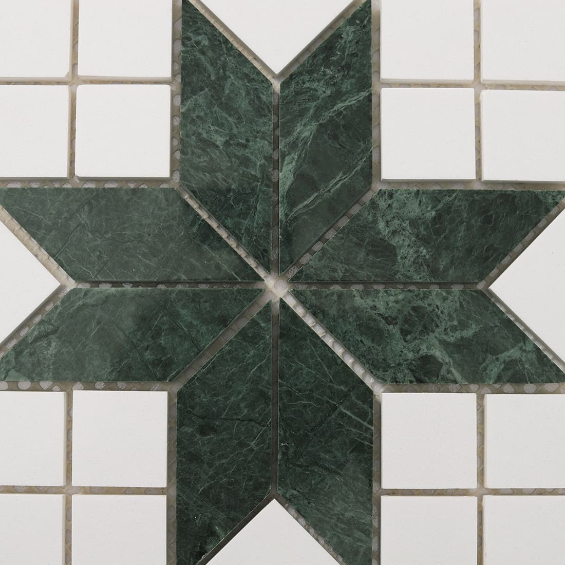 Close up of green marble star shaped geometric mosaic tile center