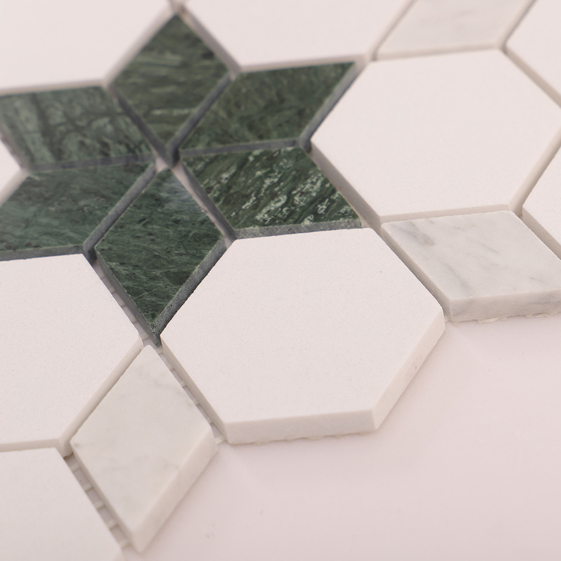 Corner detail showing green star inlay with white hexagon tiles and joints.