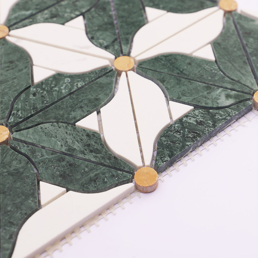Side view of green and white floral marble mosaic tile with mesh backing