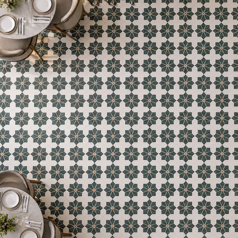 Green and white modern geometric floor tiles with floral patterns in a dining space