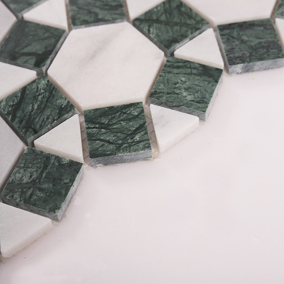 Close up showing edge thickness of green and white mosaic tile pieces