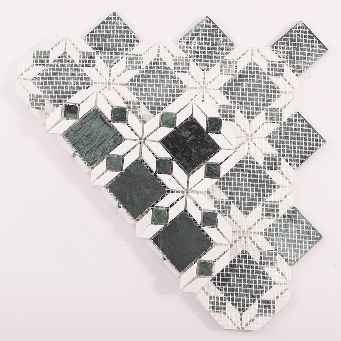 Back view of green and white marble flower mosaic tile with mesh backing