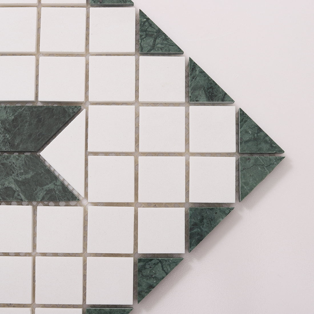 Close up of green and white marble mosaic tile edge and joint spacing