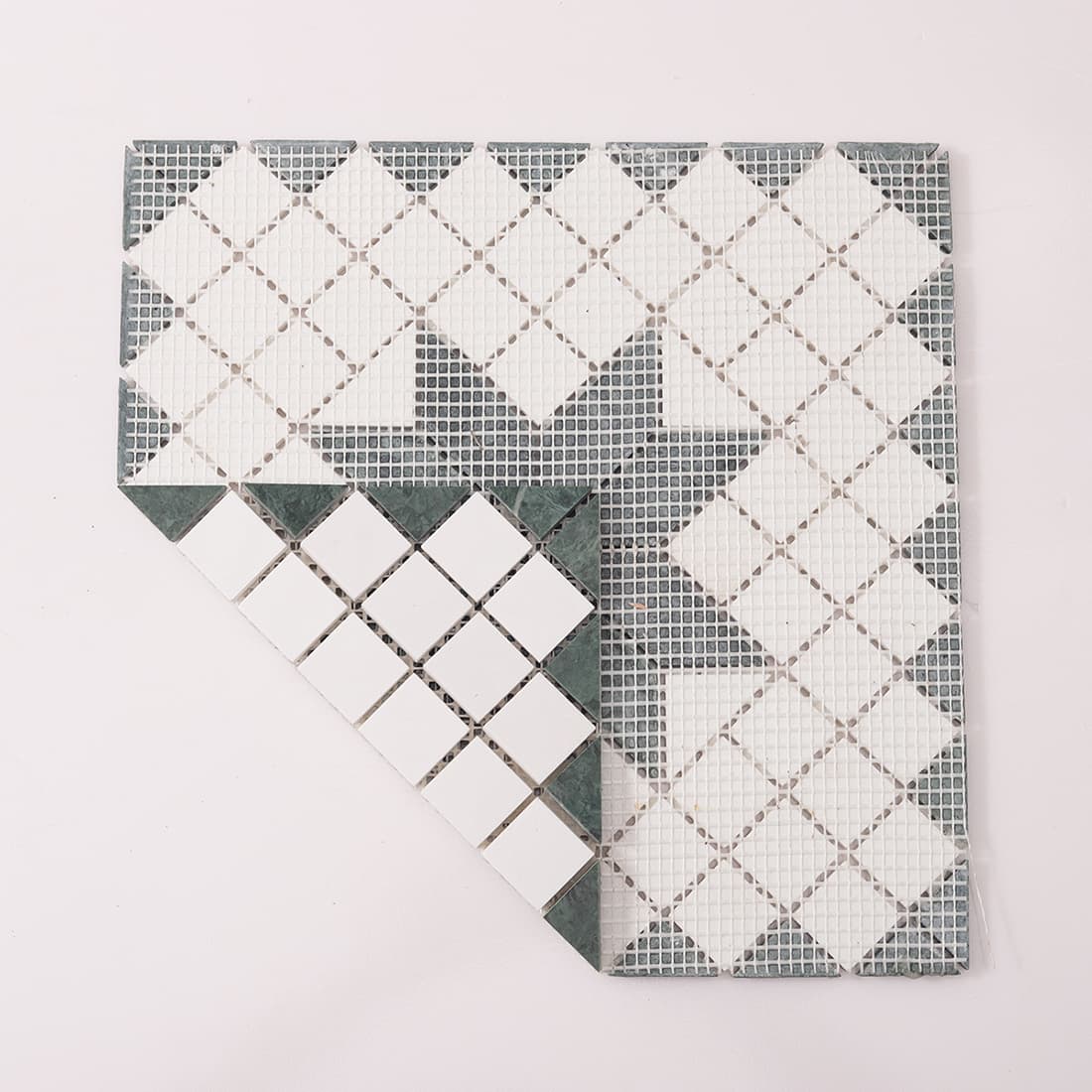 Back view of green and white marble mosaic tile with fiber mesh backing
