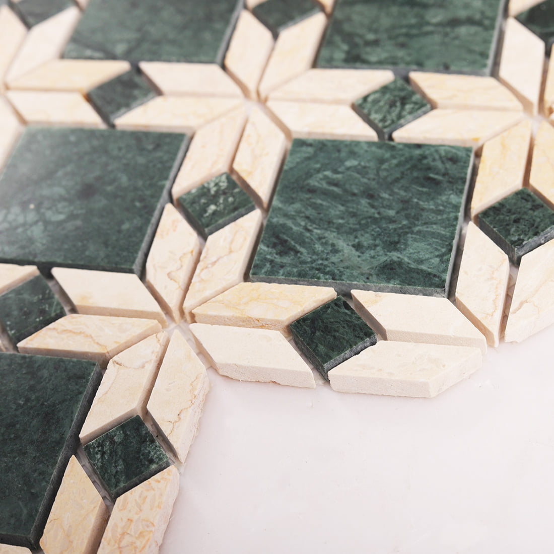 Surface detail of green and beige marble flower mosaic tile