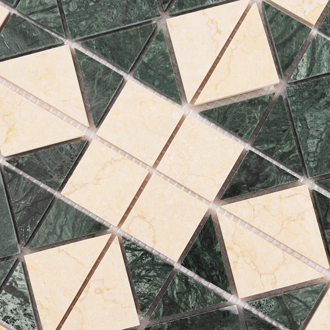 Diagonal close up of green and cream marble mosaic pattern with diamond and triangle shapes