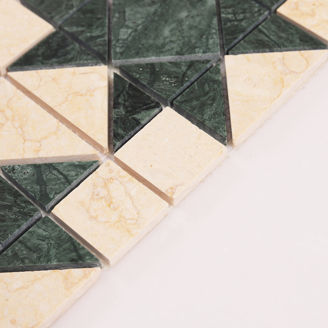 Close up showing thickness and beveled edges of green and cream marble mosaic tiles