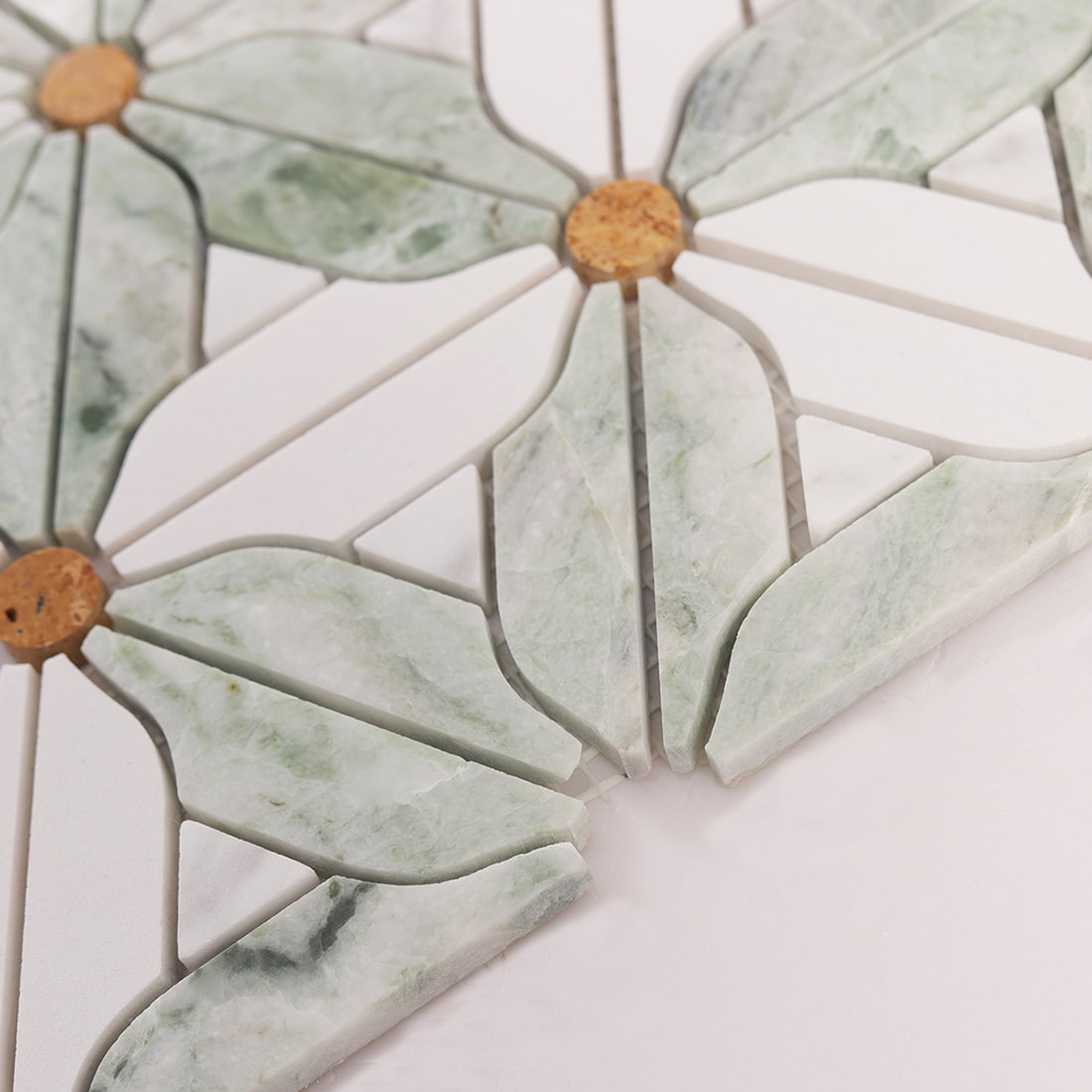 Angled close up showing thickness and edge profile of the green and white marble mosaic sheet