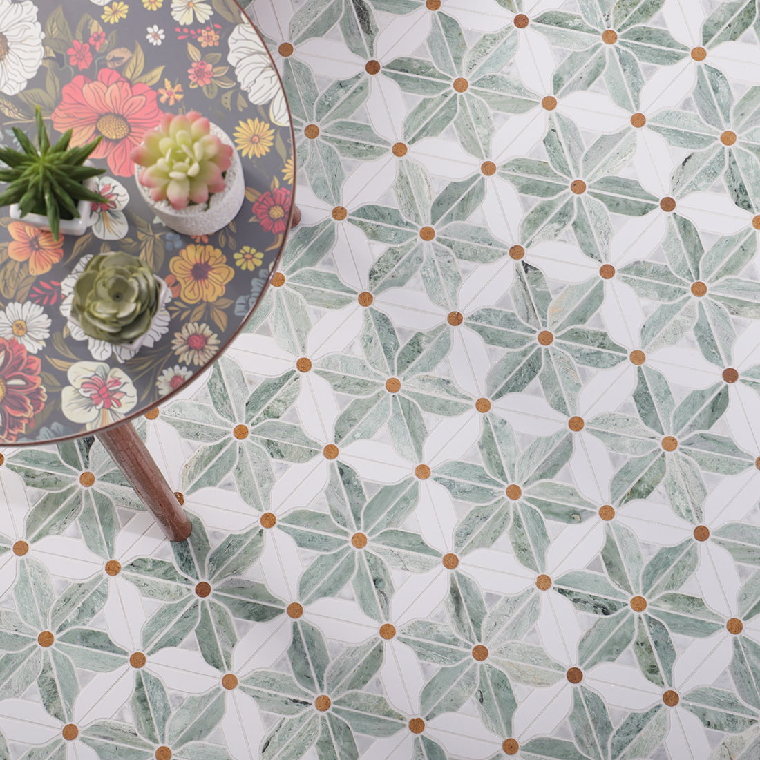 Room scene of installed green and white windmill flower mosaic floor with table 