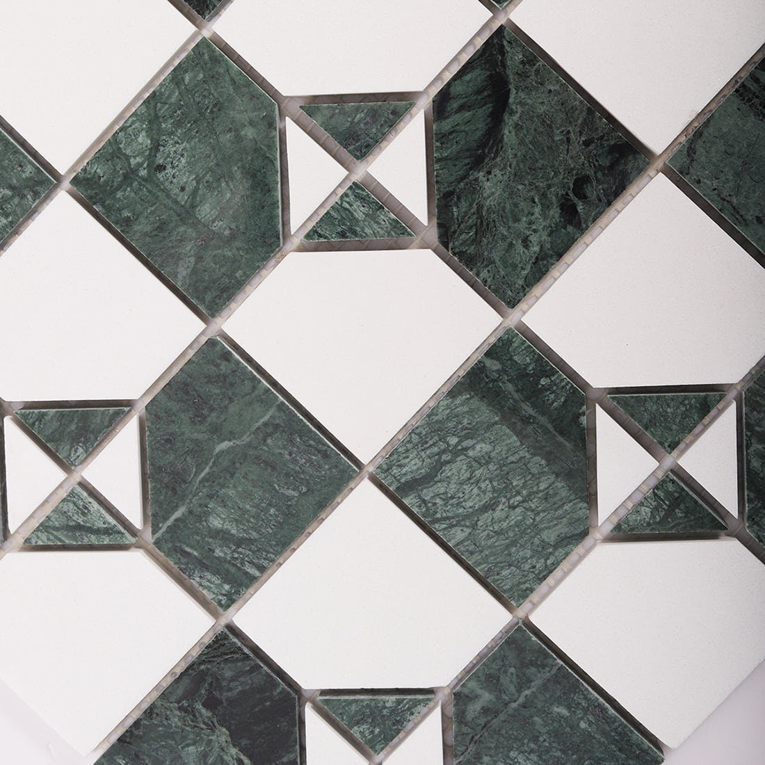 Close up of green marble and white square mosaic pattern with triangle accents