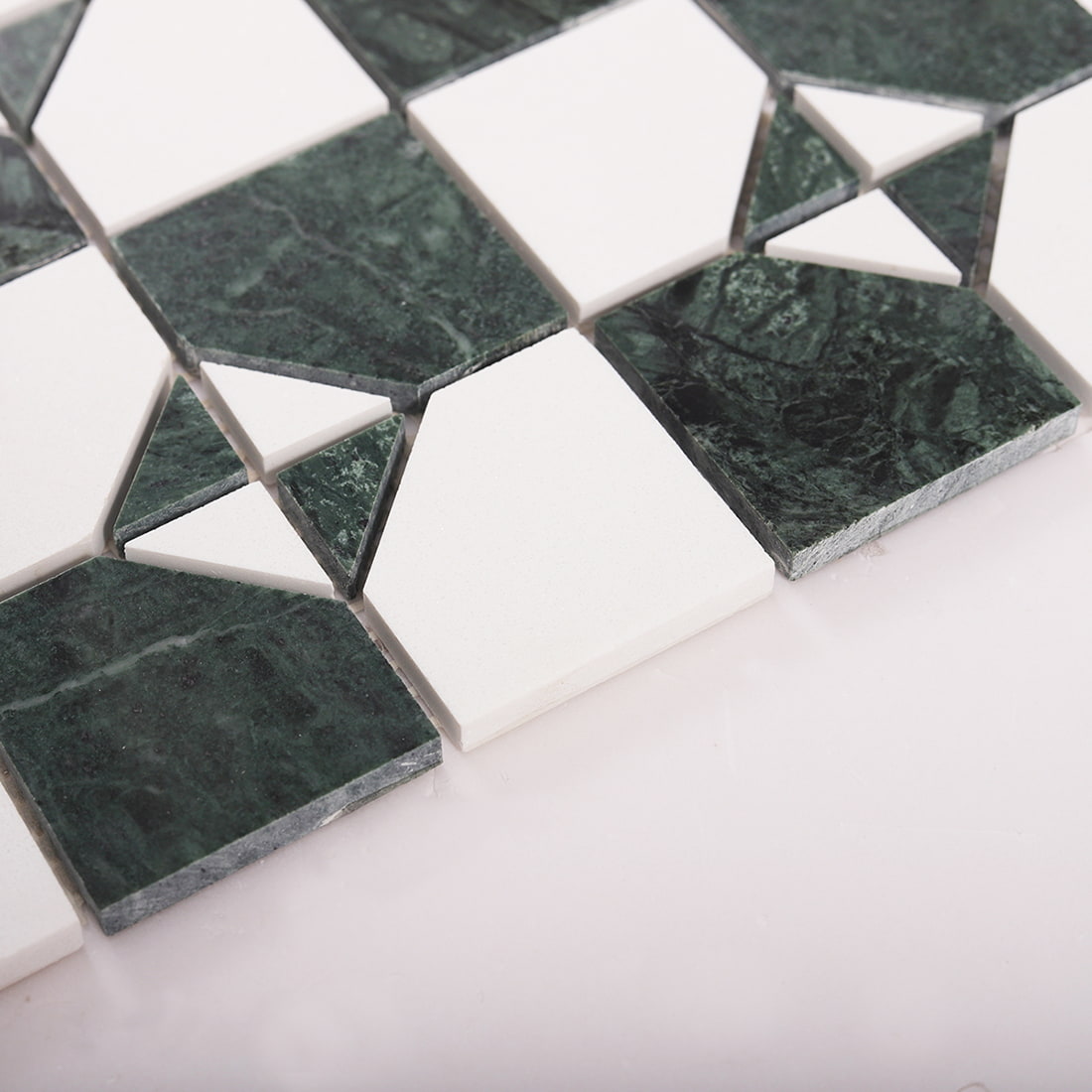 Close up of tile edge thickness on green marble and white square mosaic sheet