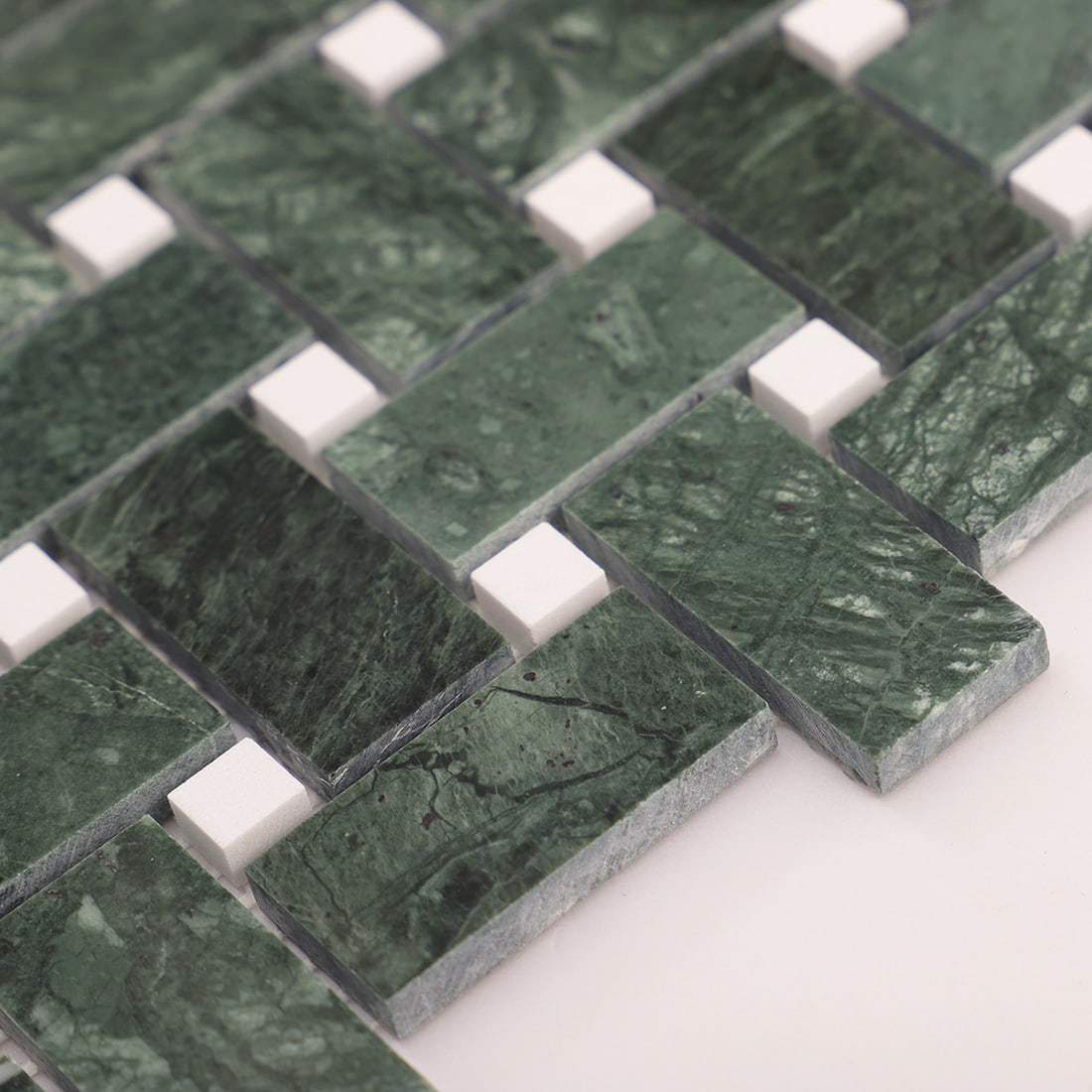 Corner edge detail of green marble basketweave mosaic sheet with white dot accents
