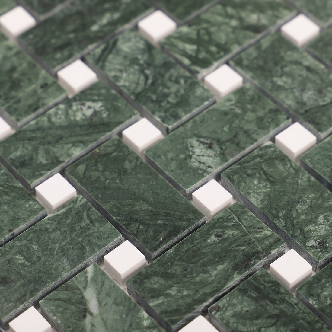Angled close-up of green marble mosaic with raised white dot squares between pieces