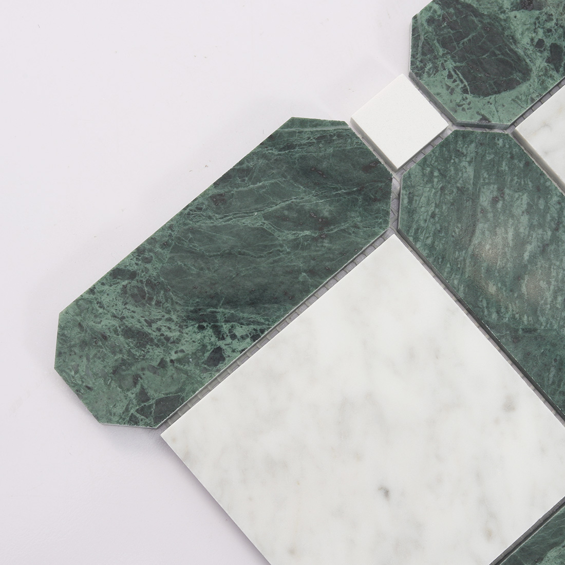 Close up of green marble border and white square mosaic tile