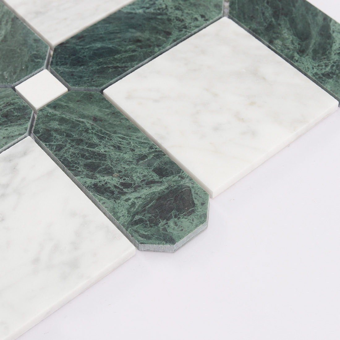 Side detail of green marble frame and white square mosaic tile pieces