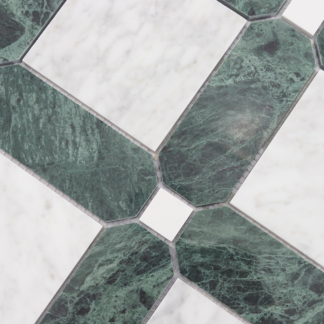 Detailed view of green marble frame around white marble square tile