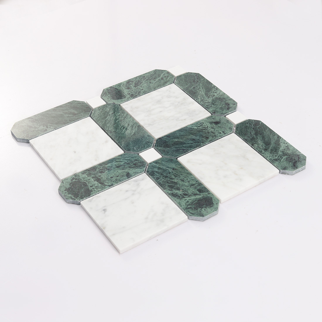 Angled view of green and white geometric marble mosaic tile sheet