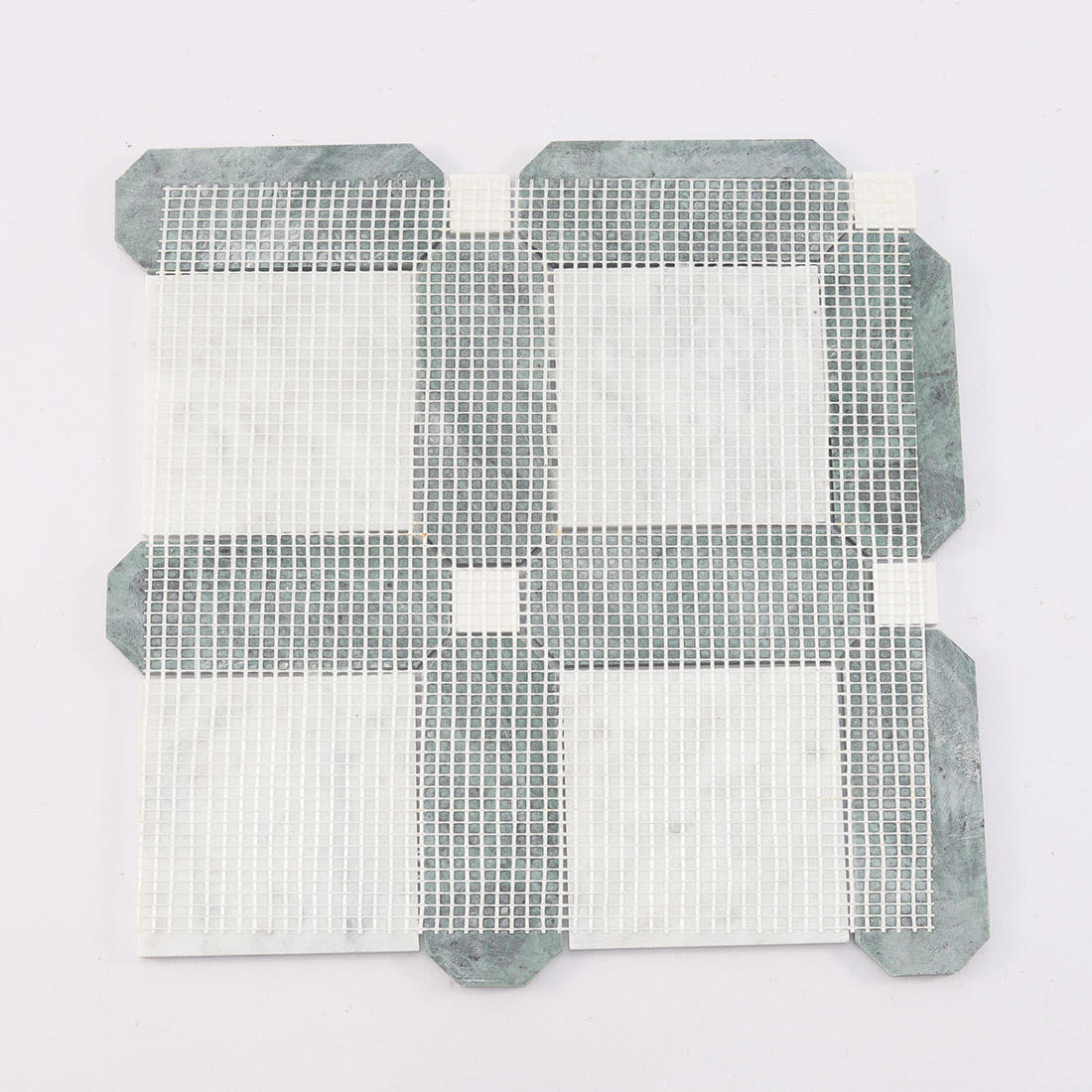 Back view of green and white marble mosaic tile with mesh backing