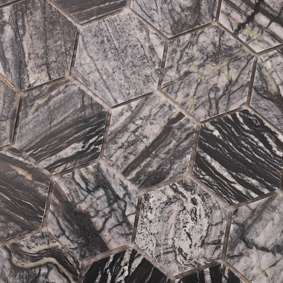 Close-up of grey and black veined marble hexagon mosaic pattern.