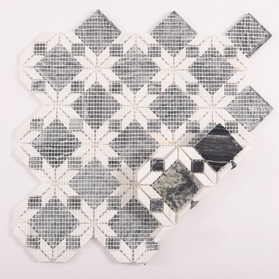 Back view of grey and white marble mosaic tile with mesh backing