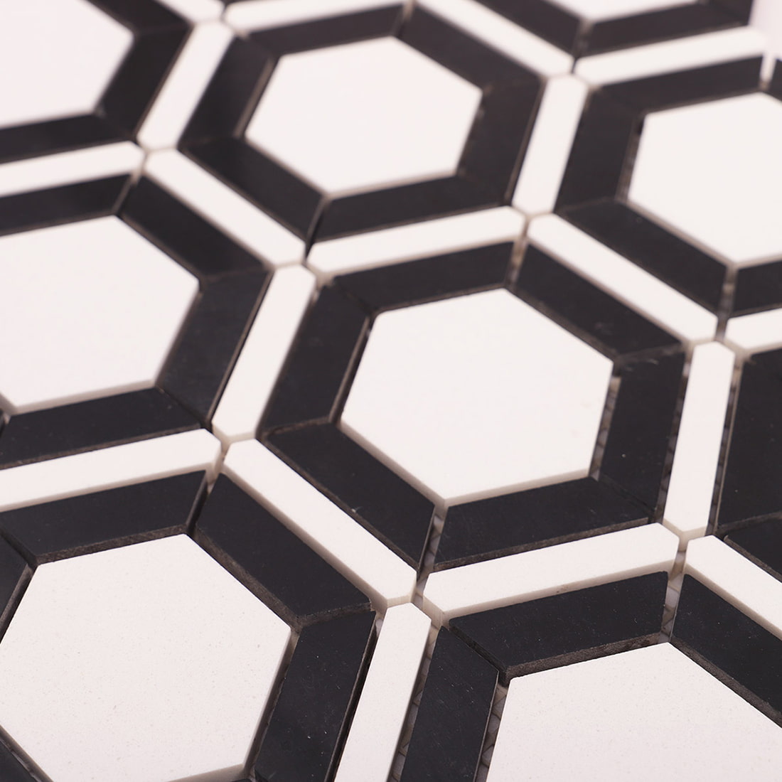 Angled close up of black and white hexagon frame mosaic surface