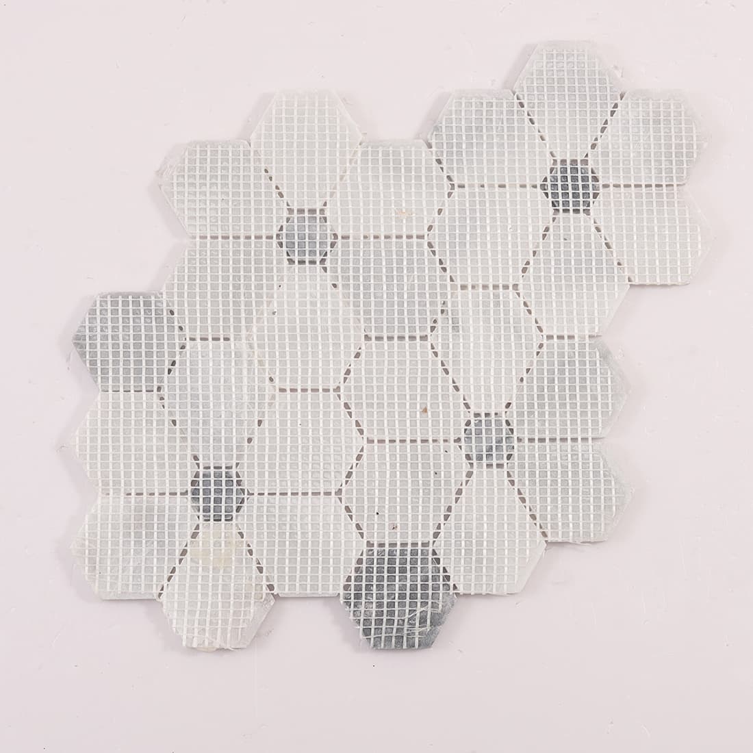 Back view of hexagon marble mosaic sheet with fiber mesh backing