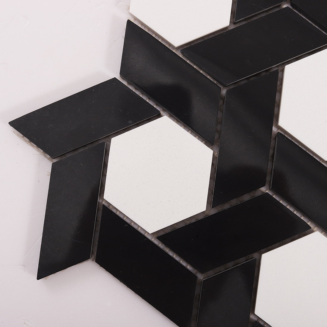 Close up of black weave mosaic with a white hexagon center