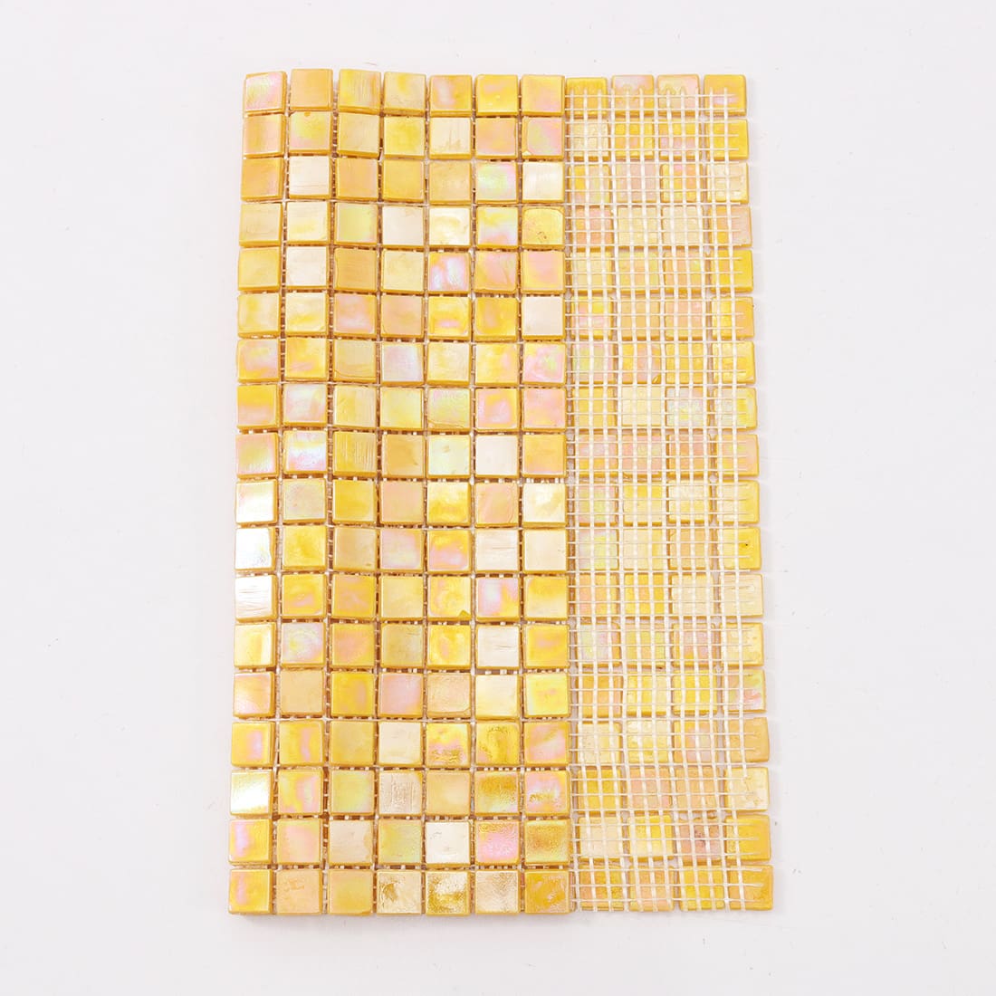  View of iridescent yellow glass mosaic tile sheet with half tiles removed to show mesh