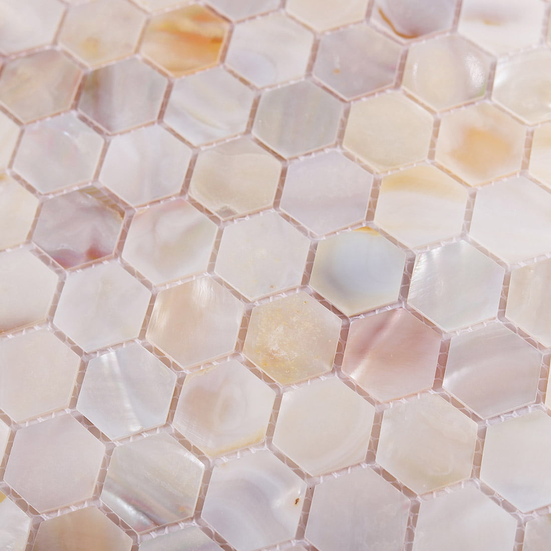 Macro view of iridescent hexagon mosaic tile texture and grout lines