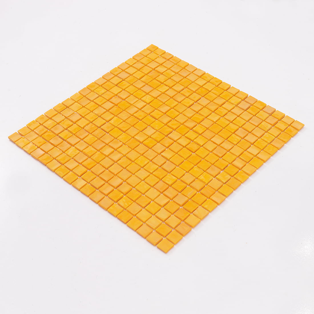A full view of a square yellow mosaic tile sheet angled to show its flat surface.