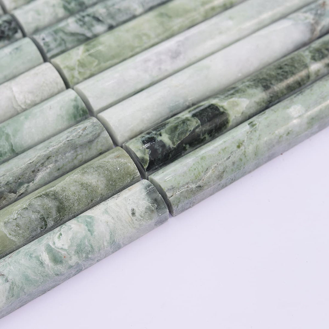Angled view of jade green marble mosaic showing rounded strips and thickness