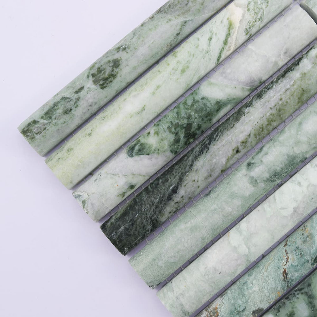 Jade green marble strips with white areas and dark forest green veining
